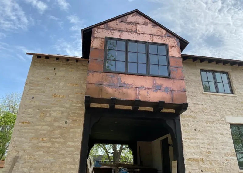Copper metal panel facade on a stone building for Roof Repair in South Abington